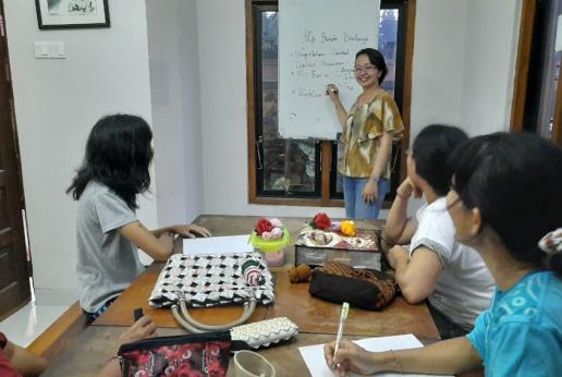 A woman is giving training on management and business canvas model to women entrepreneur